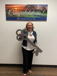 Lisa Reiter holding a large key sign
