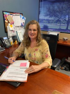 Marcie Whited at desk