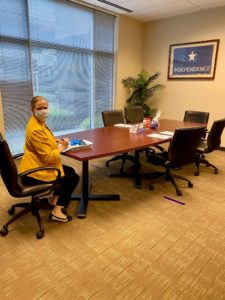 Adrienne DuBos at the closing table with Covid Mask on